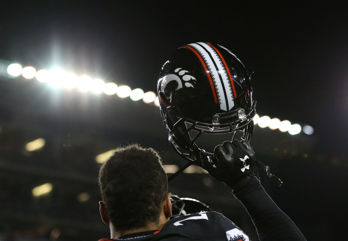 Nov 14, 2015; Cincinnati, OH, USA; Cincinnati Bearcats linebacker Eric Wilson (23) holds up his helmet after defeating the Tulsa Golden Hurricane 49-38 at Nippert Stadium. Mandatory Credit: Aaron Doster-USA TODAY Sports